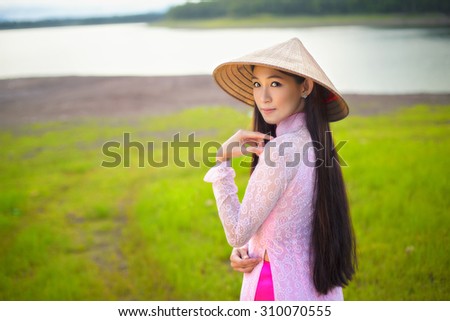Portrait of Thai girls with Ao Dai, Vietnam traditional dress, Ao dai is famous traditional costume for woman in VIetnam. Grain added, Cross process