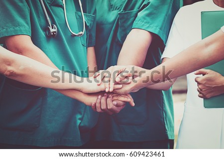 Doctors and nurses coordinate hands. Concept Teamwork in hospital for success work and trust in team