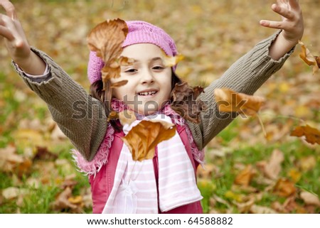 Cute girl in autumn park. Portrait shot.