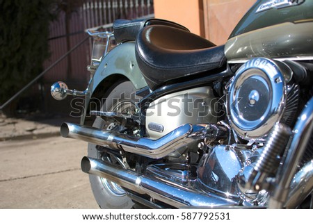 Subotica, Serbia-February 25,2017:Green Yamaha DragStar 1100 motorcycle in front of the garage, photographed on a nice sunny day. Ready for restoration. Lot of chrome detail.