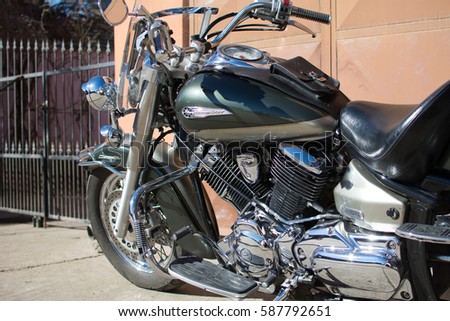 Subotica, Serbia-February 25,2017:Green Yamaha DragStar 1100 motorcycle in front of the garage, photographed on a nice sunny day. Ready for restoration. Lot of chrome detail.