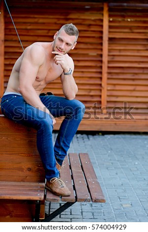 Portrait of a sitting athletic white man. Toning