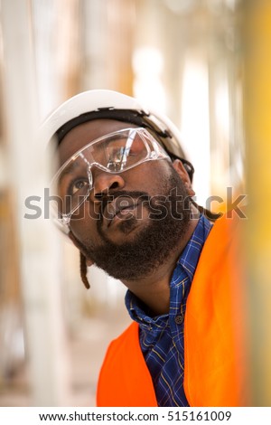 Close up of African american construction worker. Low angle view