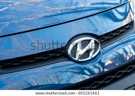 Berlin, Germany: March 12, 2017: Mazda logo on blue shiny car. Front view. Mazda Motor Corporation is a Japanese multinational automaker founded in 1928