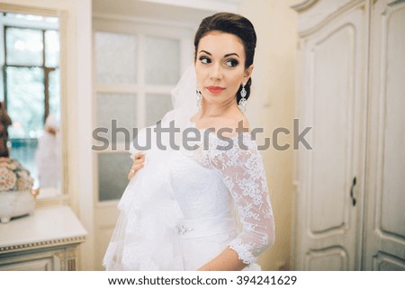 https://thumb7.shutterstock.com/display_pic_with_logo/2983087/394241629/stock-photo-beautiful-young-bride-with-wedding-makeup-and-hairstyle-in-bedroom-happy-bride-waiting-groom-394241629.jpg