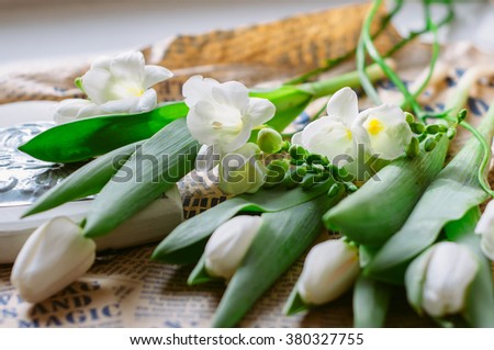 international women's day 8 march card. white flowers bouquet on neutral background. wooden white and vintage newspaper background. rustic style decoration