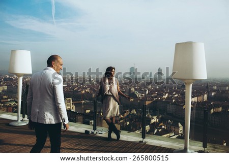 stock photo wonderful rich groom looking at bride on the terrace on the background of blue sky lyon city 265800515