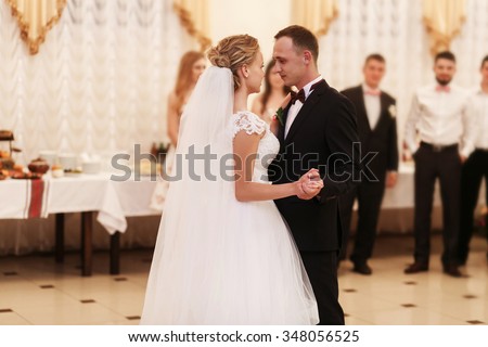 https://thumb7.shutterstock.com/display_pic_with_logo/2988610/348056525/stock-photo-stylish-romantic-young-couple-dancing-waltz-on-their-wedding-day-in-luxury-restaurant-hall-against-348056525.jpg