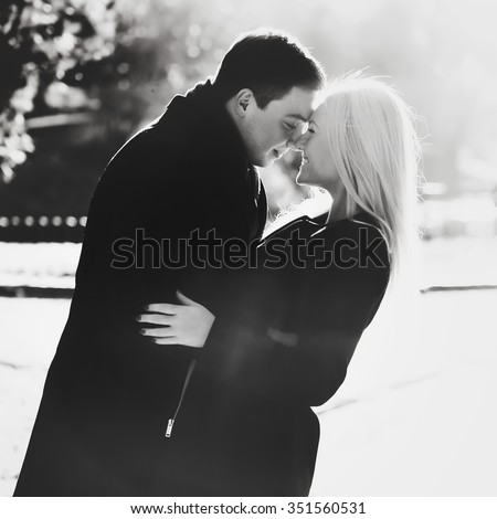 https://thumb7.shutterstock.com/display_pic_with_logo/2988610/351560531/stock-photo-beautiful-young-couple-walking-and-kissing-in-the-autumn-park-black-and-white-photo-351560531.jpg
