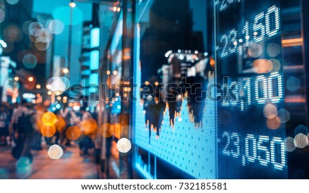 Display of Stock market quotes with city scene reflect on glass