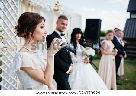 https://thumb7.shutterstock.com/display_pic_with_logo/3026468/526970929/stock-photo-master-of-ceremony-speech-on-microphone-background-wedding-couple-526970929.jpg