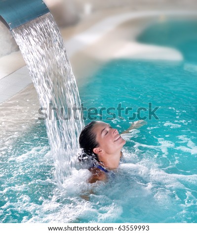 spa hydrotherapy woman waterfall jet turquoise swimming pool water
