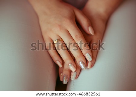 A closeup of woman's wedding manicure