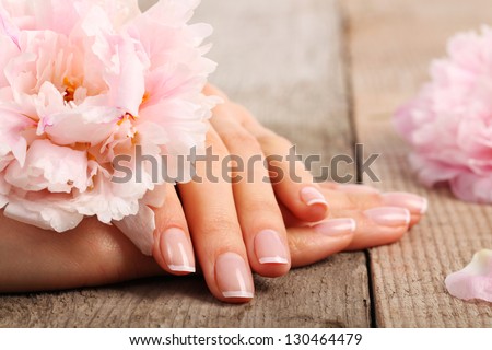 Woman in a nail salon receiving a manicure