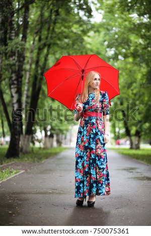 https://thumb7.shutterstock.com/display_pic_with_logo/3049580/750075361/stock-photo-girl-in-the-street-with-an-umbrella-for-a-walk-on-a-summer-day-750075361.jpg