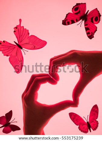 Hands in the form of heart red background. heart symbol with hand. valentines day card. Woman's hands silhouette in form of heart. hand Gestures