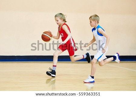 stock-photo-girl-and-boy-athlete-in-sport-uniform-playing-basketball-559363351.jpg