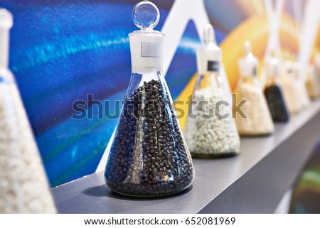 Plastic granular polymer. Samples in flasks