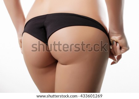 female ass in black panties on a white background