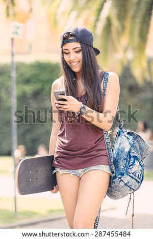 https://thumb7.shutterstock.com/display_pic_with_logo/308011/287455484/stock-photo-portrait-of-a-beautiful-skater-girl-looking-at-smart-phone-at-park-she-is-half-caucasian-and-half-287455484.jpg