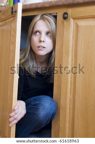 Young Woman Hiding Cupboard Stock Photo 61618963 - Shutterstock