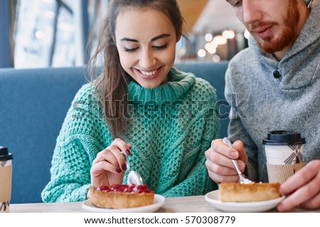 https://thumb7.shutterstock.com/display_pic_with_logo/309106/570308779/stock-photo-couple-eating-a-dessert-in-a-cafe-on-a-date-and-drinking-coffee-woman-and-man-looks-at-a-spoon-570308779.jpg