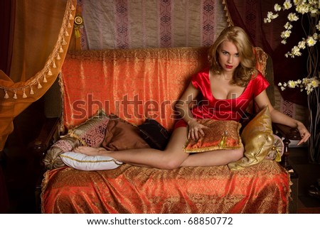 http://thumb7.shutterstock.com/display_pic_with_logo/310210/310210,1294865312,1/stock-photo-portrait-of-the-beautiful-woman-in-a-red-east-interior-68850772.jpg