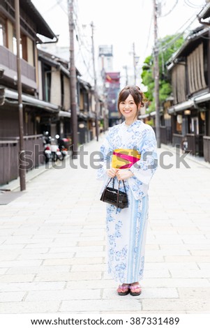 https://thumb7.shutterstock.com/display_pic_with_logo/310660/387331489/stock-photo-attractive-asian-woman-wearing-kimono-walking-on-the-old-street-387331489.jpg