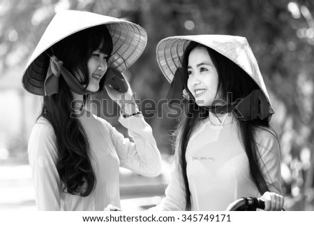 Ho Chi Minh City, Vietnam - September 13rd, 2015: A girl student was watching her friend with a smile and beautiful bright eyes showing innocent beauty of students in Vietnam
