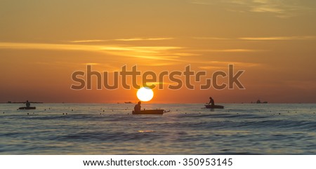 Quang Ngai, Vietnam, June 27th, 2015: Men on boats fishing near the shore in early morning in Quang Ngai, Vietnam