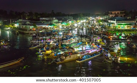 Soc Trang, Vietnam - February 3rd, 2016: Landscape Floating Market at night with bustling boats crossing river in roundabout sales agricultural products prepare welcome New Year in Soc Trang, Vietnam