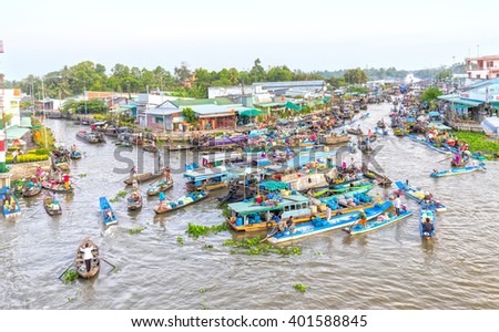 Soc Trang, Vietnam - February 3rd, 2016: Agricultural morning floating market bustling with boatload rotation trafficking intersection into river in sunny as wetland culture in Soc Trang, Vietnam