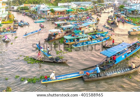 Soc Trang, Vietnam - February 3rd, 2016: Trade agricultural products in morning floating market with boatload full concentrated rotation rhythm in filthy rivers wetland sale in Soc Trang, Vietnam