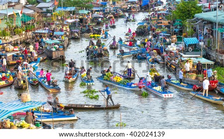 Soc Trang, Vietnam - February 3rd, 2016: Buying and selling agricultural products on river crowded with boats fruit, flowers, agricultural products on busiest floating market in Soc Trang, Vietnam