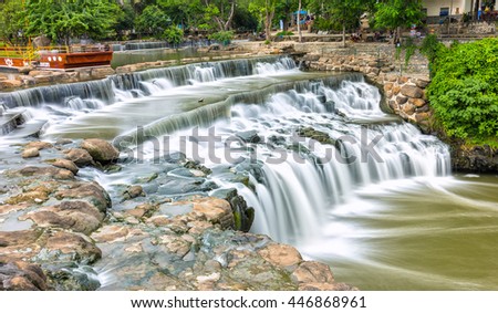 Dong Nai, Vietnam - June 19th, 2016: Falls in park destinations summer morning with water flowing down smooth as silk sheet stone steps natural scenery beautiful attract tourists to relax on weekend