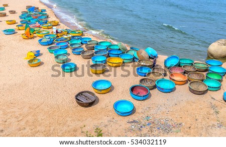 Binh Thuan, Vietnam - July 26th, 2016: Ganh Son Beach on sunny afternoon with many basket boats lined beach, this is beautiful coastline attract tourists to visit in Binh Thuan, Vietnam