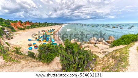 Binh Thuan, Vietnam - July 26th, 2016: Ganh Son Beach on sunny afternoon with many basket boats lined beach, this is beautiful coastline attract tourists to visit in Binh Thuan, Vietnam