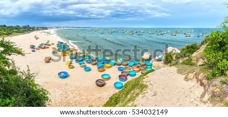 Binh Thuan, Vietnam - July 26th, 2016: Ganh Son Beach on sunny afternoon with many basket boats lined beach, this is beautiful coastline attract tourists to visit in Binh Thuan, Vietnam