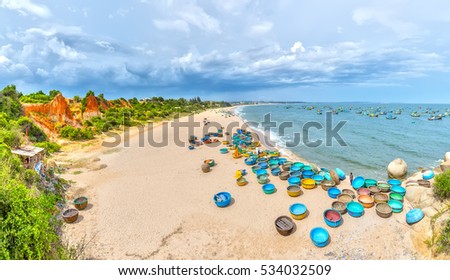 Binh Thuan, Vietnam - July 26th, 2016: Ganh Son Beach on sunny afternoon with many basket boats lined beach, this is beautiful coastline attract tourists to visit in Binh Thuan, Vietnam