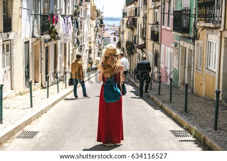 https://thumb7.shutterstock.com/display_pic_with_logo/3151337/634116527/stock-photo-young-travel-woman-is-walking-on-the-beautiful-old-cozy-street-of-lisbon-in-portugal-634116527.jpg