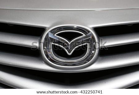 CRACOW, POLAND - MAY 21, 2016: Mazda metallic logo closeup on Mazda car displayed at 3rd edition of MOTO SHOW in Cracow Poland. Exhibitors present most interesting aspects of the automotive industry