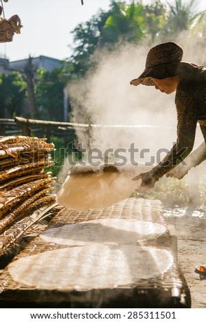CAN THO, VIETNAM - NOV 10, 2013: Unidentified woman making rice noodles in Mekong delta in Can Tho, Vietnam on November 10, 2013.