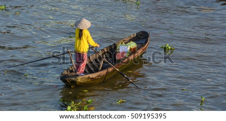 Soc Trang, Vietnam - Feb 2, 2016. A woman with wooden boat at Nga Nam floating market in Soc Trang, southern Vietnam. Nga Nam is one of famous market in southern Vietnam.