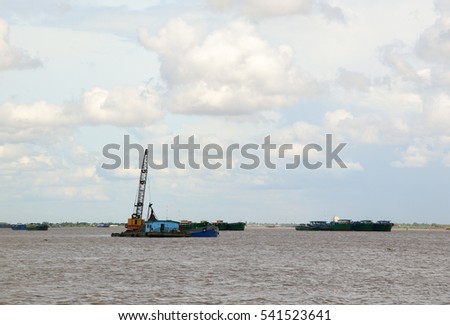 Landscape of Mekong River in Southern Vietnam. A cargo boat carrying sand on the river in Chau Doc, An Giang, Vietnam.