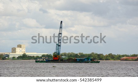Landscape of Mekong River in Southern Vietnam. A cargo boat carrying sand on the river in An Giang, Vietnam.