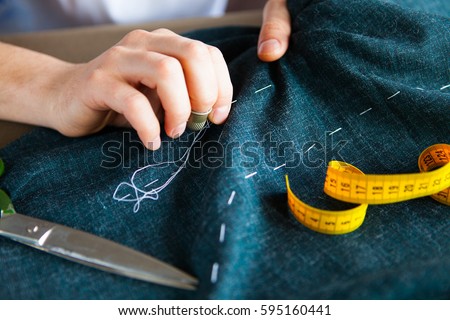 Tailor man working in his tailor shop, Tailoring, close up