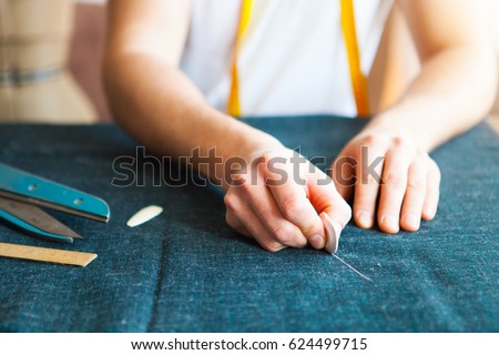 Tailor man working in his tailor shop, Tailoring, close up