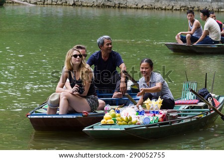 NINHBINH, VIETNAM - May 17, 2015: Unidentified Vietnamese persons on the Floating Market at "Ngo Dong" river in Tam Coc Bich Dong heritage, NinhBinh province, Vietnam.