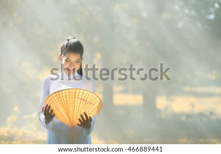 Portrait of Thai girls with Ao Dai.Asian woman dressed in traditional Vietnamese Portrait of Thai girls with Ao Dai, Ao dai is famous traditional costume for woman in VIetnam.