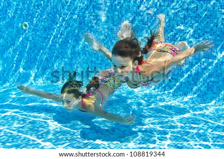 happy smiling underwater children in swimming pool beautiful girls swim and having fun kids - Kids Swimming Underwater happy smiling underwater children in swimming pool beautiful girls swim and having fun kids - Kids Swimming Underwater